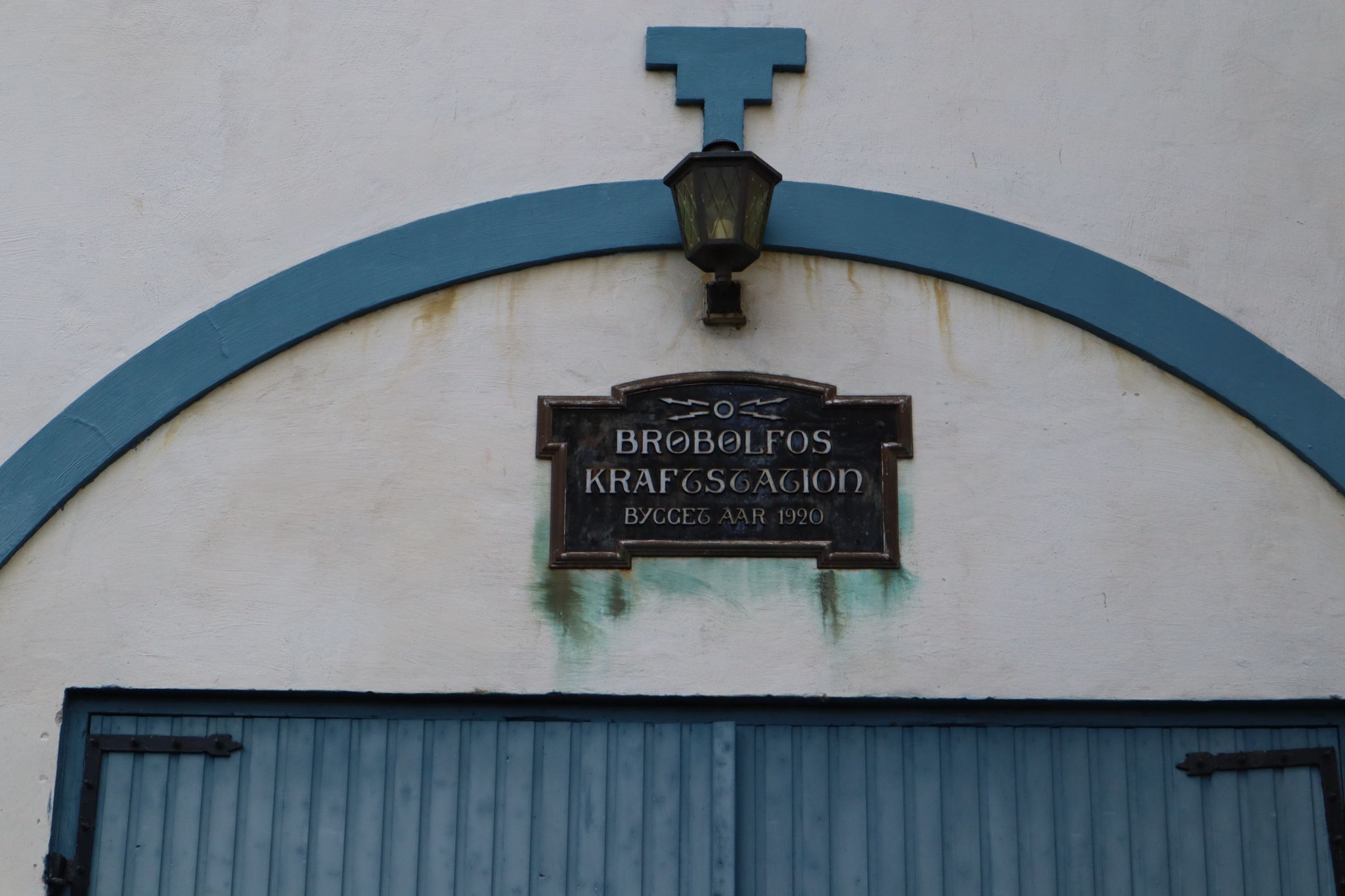 Skiltet over porten inn til maskinhallen forteller at her har det vært kraftproduksjon i snart 100 år.
