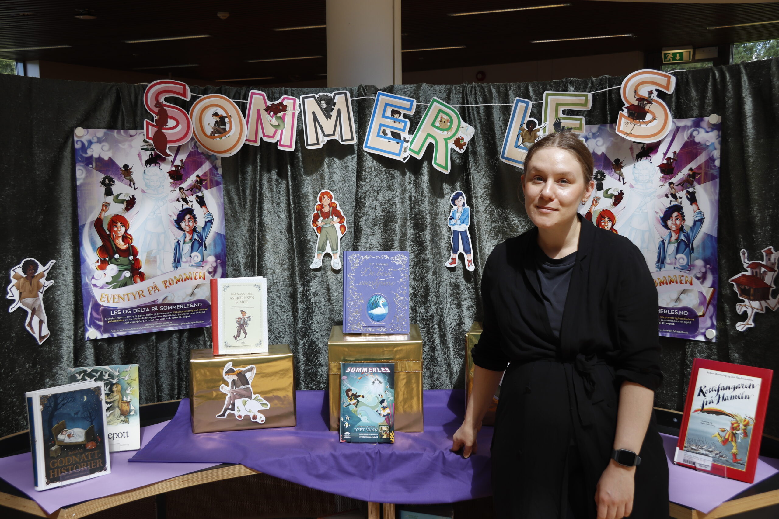 Unnveig Aaserud Stokke deler ut premier til barna som tjener poeng i appen til Sommerles.