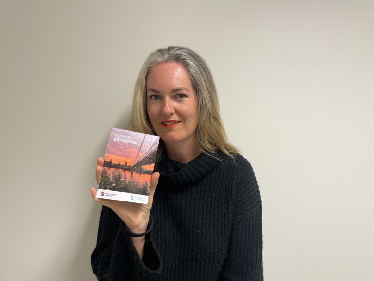 Brandval Utvikling har i høst gitt ut en ny brosjyre om Brandval. Her viser leder i Brandval Utvikling Ann Kristin Torgersen Aamodt frem produktet.