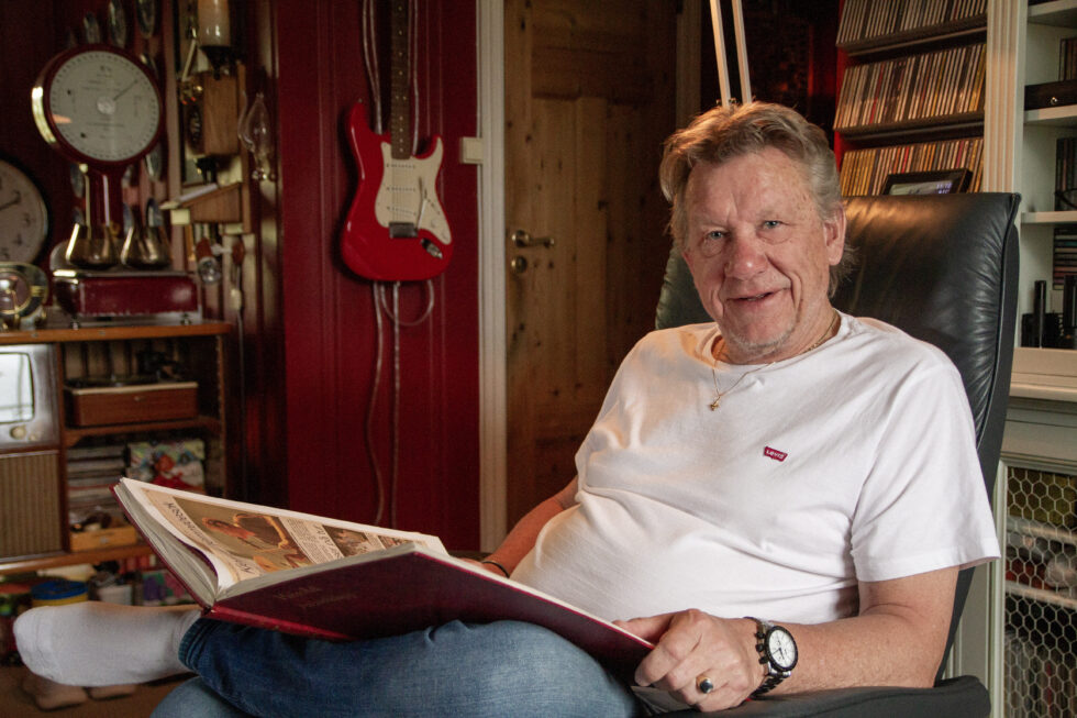 Erik Øverby hjemme i stua med en av mange utklippsbøker som dokumenterer over 45 år i musikkens tjeneste.